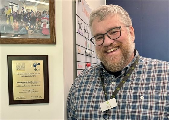 COA ComDev Director Ben Anderson in front of Planning Award