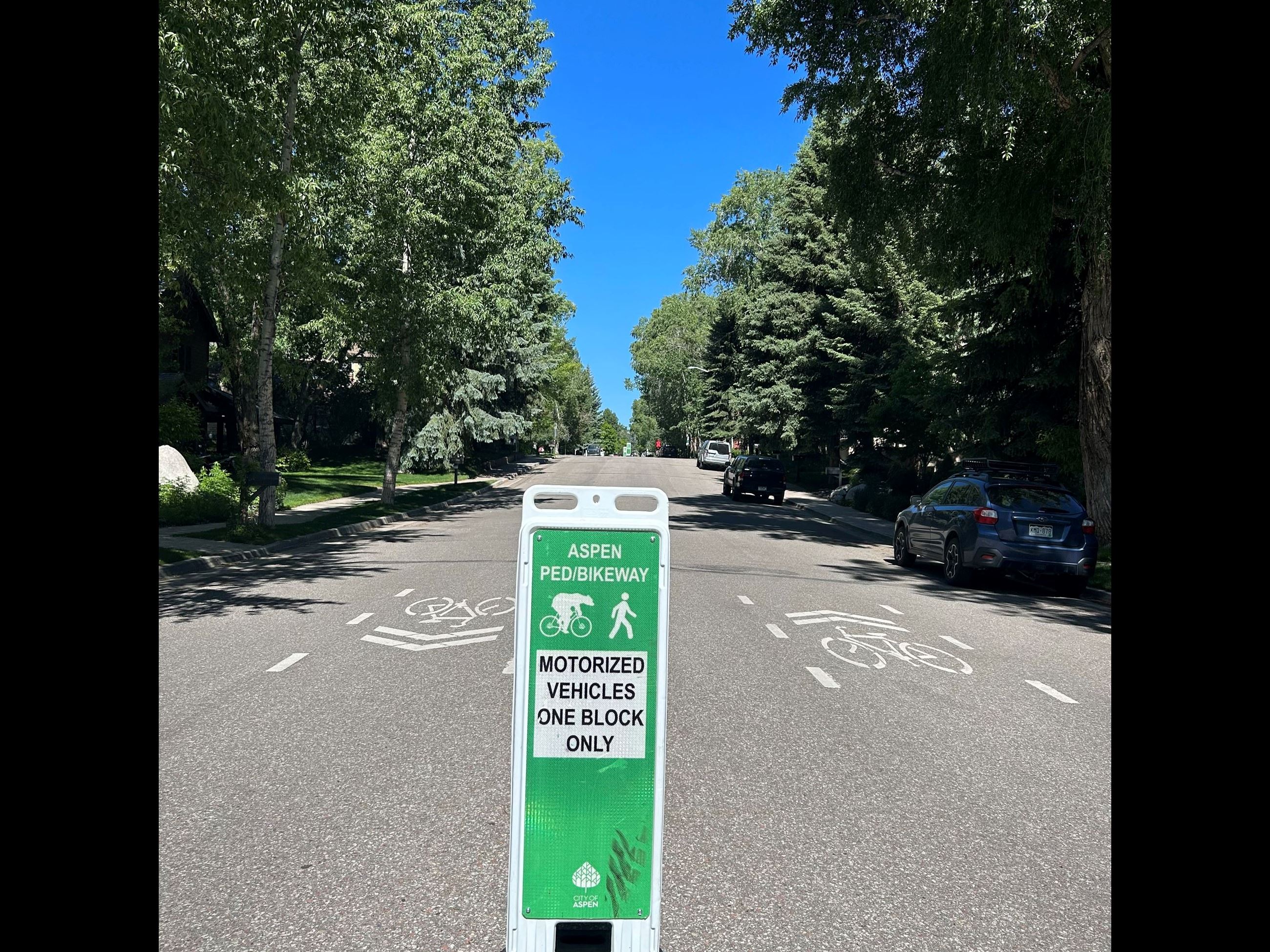 green and white pedestrian bike way sign 