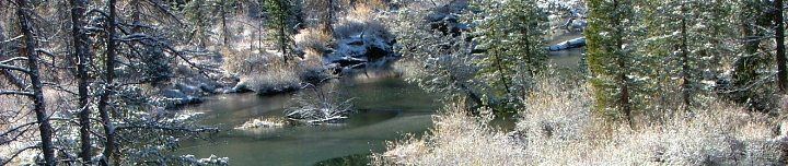 Snow covered banks by a river