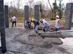 Construction workers pouring concrete