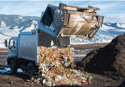white garbage truck dumping trash at pitkin county landfill